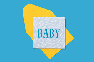 Baby Blue Gift Enclosure Card with white marble texture and teal text on yellow geometric background.
