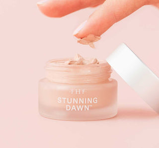 FHF Stunning Dawn Brightening Eye Cream in elegant glass jar, radiating luxury and promising vibrant, youthful eyes.