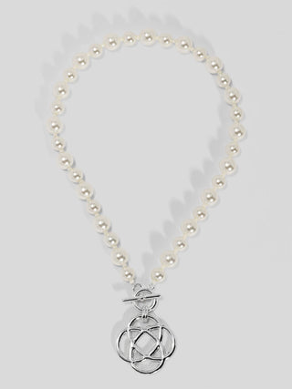 Cream pearl beaded necklace with silver-tone toggle clasp and interlocking circular charm pendant.
