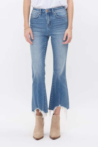Model wearing Mica F124 Medium Wash High Rise Crop Flare Jeans with non-distressed denim, front view.