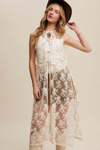 Elegant cream embroidered lace sleeveless duster by Listicle, perfect for layering or adding sophistication to any outfit.