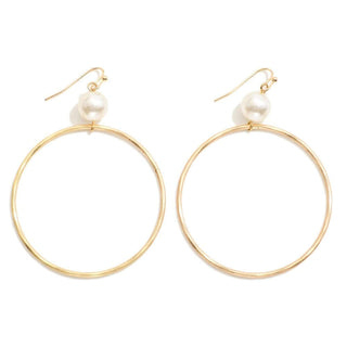 Alt text: Elegant gold hoop drop earrings with delicate pearl detail, perfect for adding sophistication to any outfit.