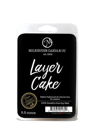 Milkhouse Candles Layer Cake Wax Melts in final sale packaging on a rustic wooden surface.