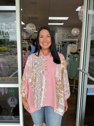 Soft pink floral oversized top with half placket, crochet detail, and long sleeves by POL, ideal for casual chic looks.