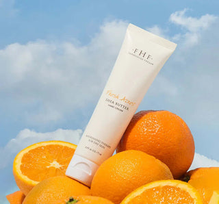 Farmhouse Fresh Fresh Acres Shea Butter Hand Cream tube against a rustic wooden background, offering nourishing moisture.