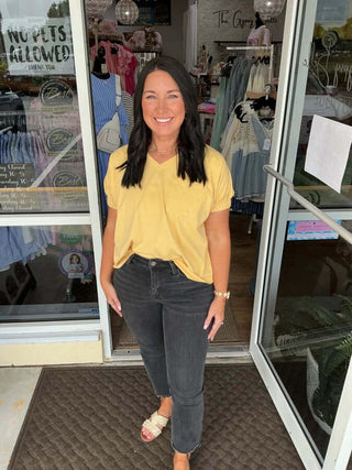 Honey Gold Mineral Washed Cap Sleeve Pocket Top on hanger, showcasing casual style and soft fabric in a trendy design.