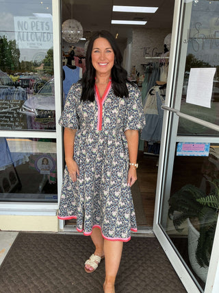 Navy floral print dress with contrast stripe, elegant and chic. Perfect for any occasion. Shop the VOY collection now.