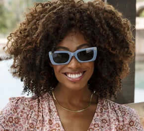 Stylish Skipper Blue Sun Readers by Peepers with round frames and tinted lenses on a white background.