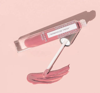 FHF Vitamin Glaze Oil-Infused Lip Gloss in Delicate Rose shade with sleek packaging, adds shine and nourishment.