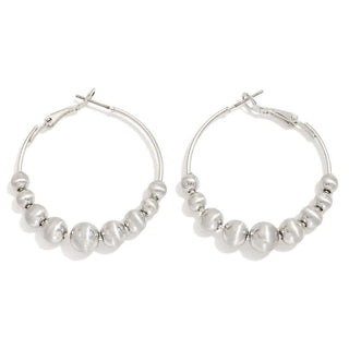 Close-up of elegant Silver Graduated Bead Hoop Earrings with a polished finish, showcasing varying bead sizes for added dimension.